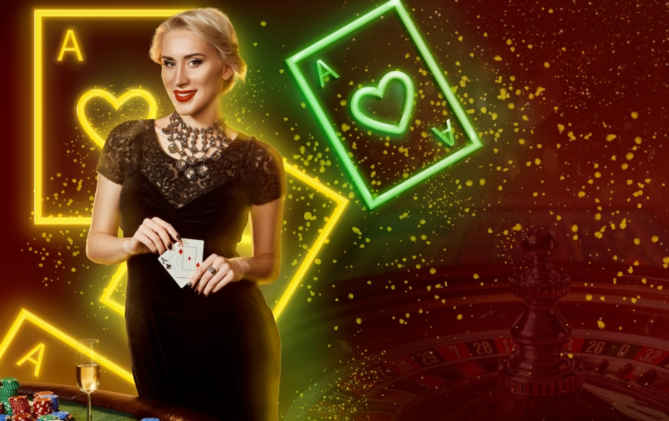 Blonde girl in black dress, jewelry. Showing two aces, smiling, posing at table with stacks of chips and champagne on it. Colorful background with neon playing cards, roulette. Poker, casino. Close-up